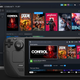 The Steam Deck device in front of a laptop showcasing someone's library of games on the Valve platform.